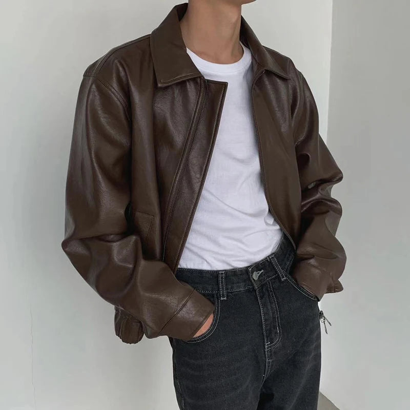 Model in brown boxy faux leather jacket over a white tee, front view