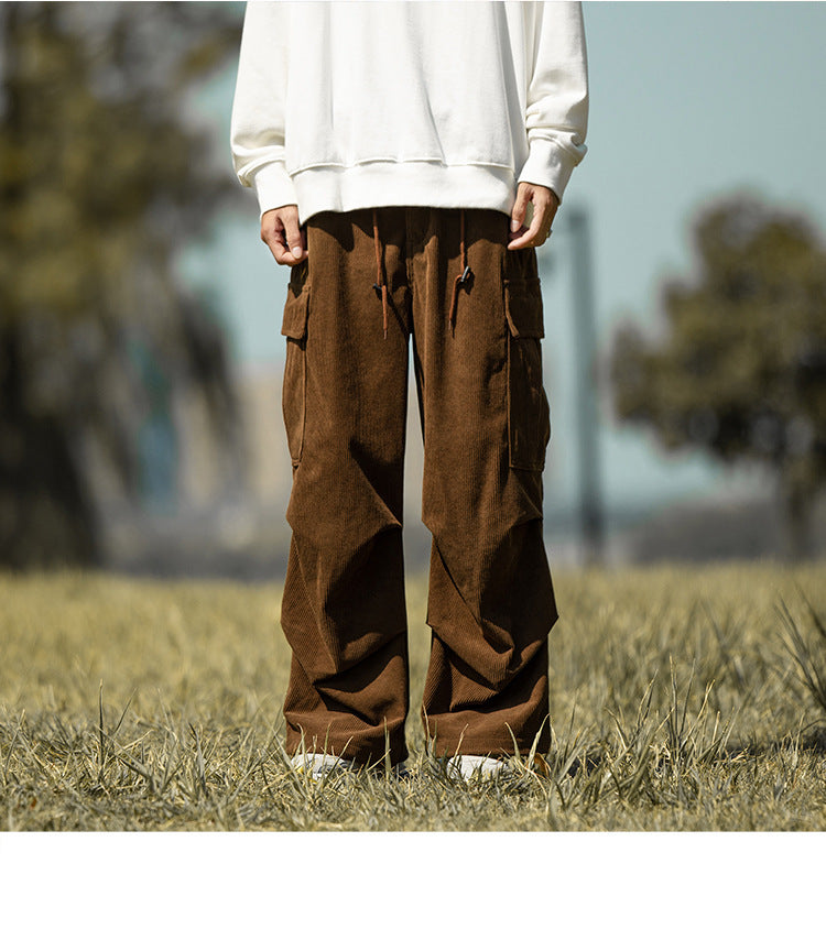 Model in brown corduroy wide-leg cargo pants with a cream sweatshirt, front view