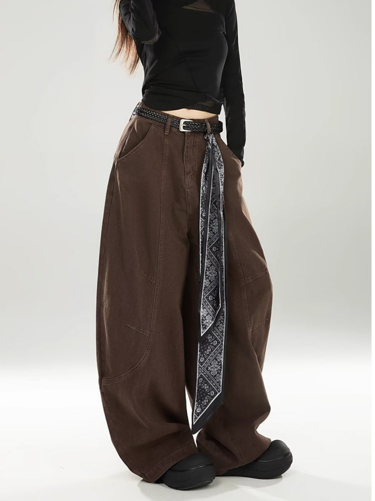 Chocolate brown barrel-leg jeans, side view showing the curved leg