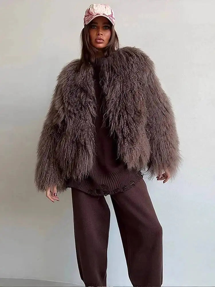 Model in shaggy faux fur cropped jacket with brown knit pants