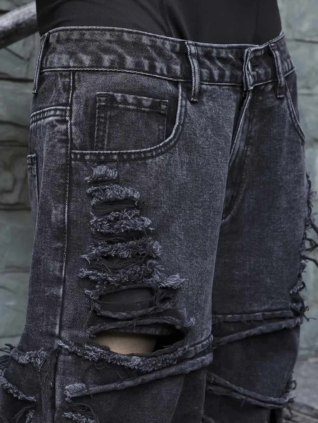 Men's black jeans. With a design of (ripped holes) and tassels. In a street trend style.