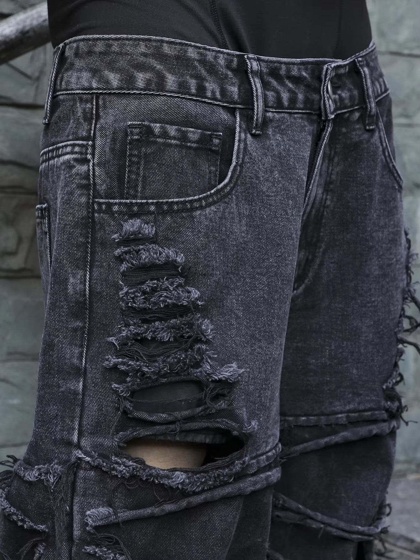 Men's black jeans. With a design of (ripped holes) and tassels. In a street trend style.