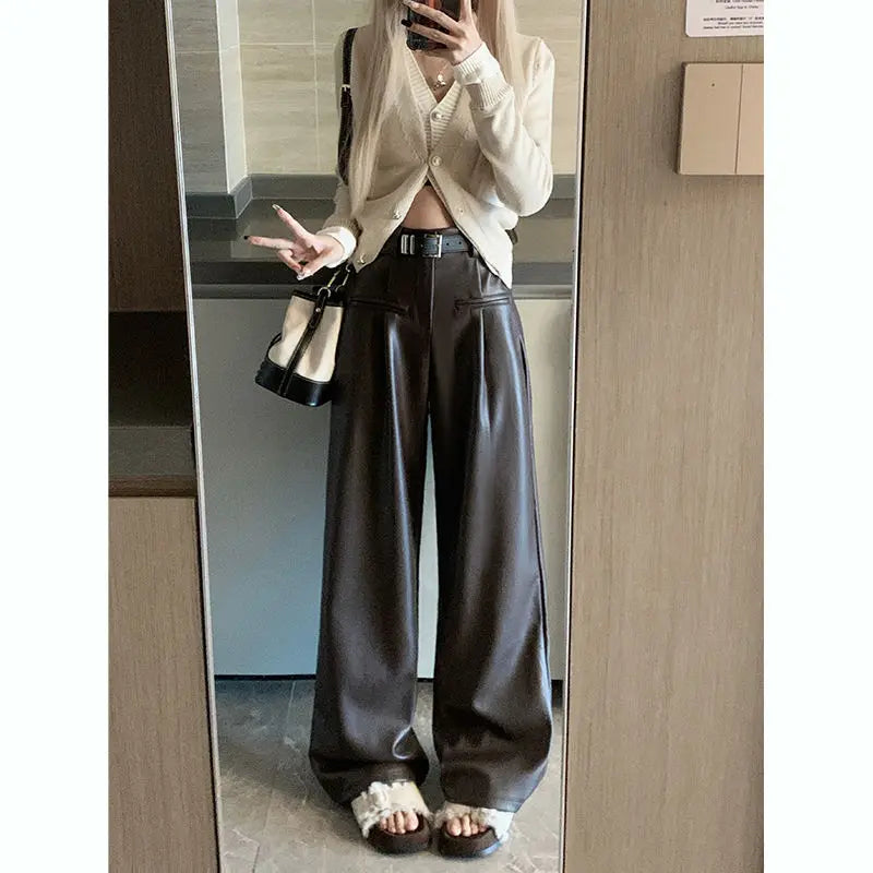Mirror photo of model in brown faux leather wide-leg pants, front view