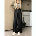 Model in black faux leather high-waisted wide-leg pants, full front view