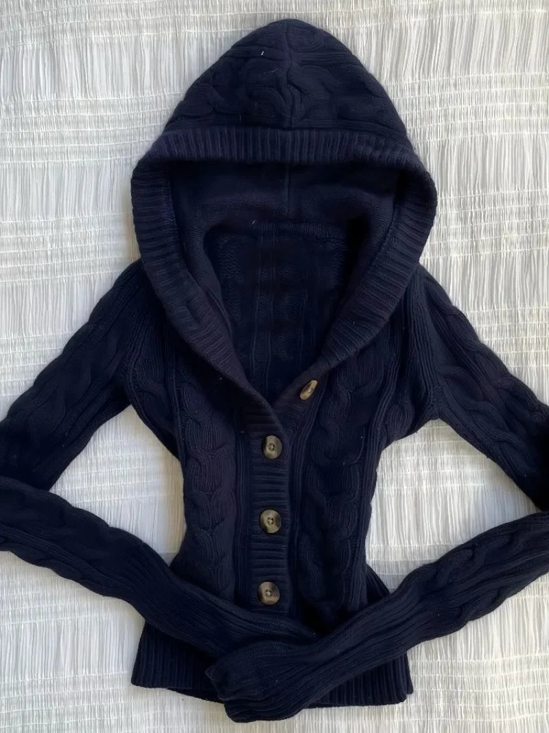 Navy hooded cable-knit cardigan laid flat, showing the hood and button front