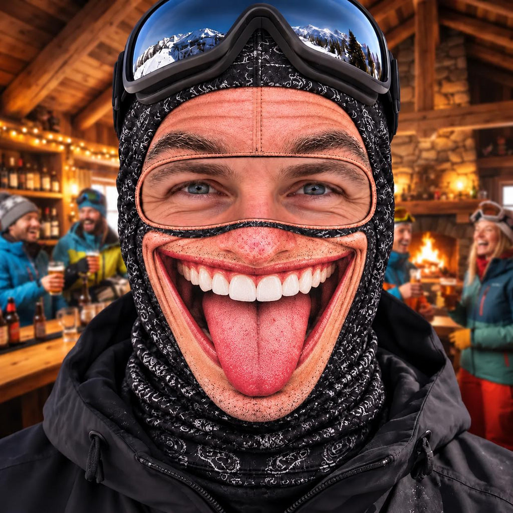 May include: A black balaclava featuring a realistic, high-definition print of a wide, grinning mouth with white teeth and a protruding tongue. The headgear includes a cutout for the eyes and is worn with black ski goggles on the forehead.
