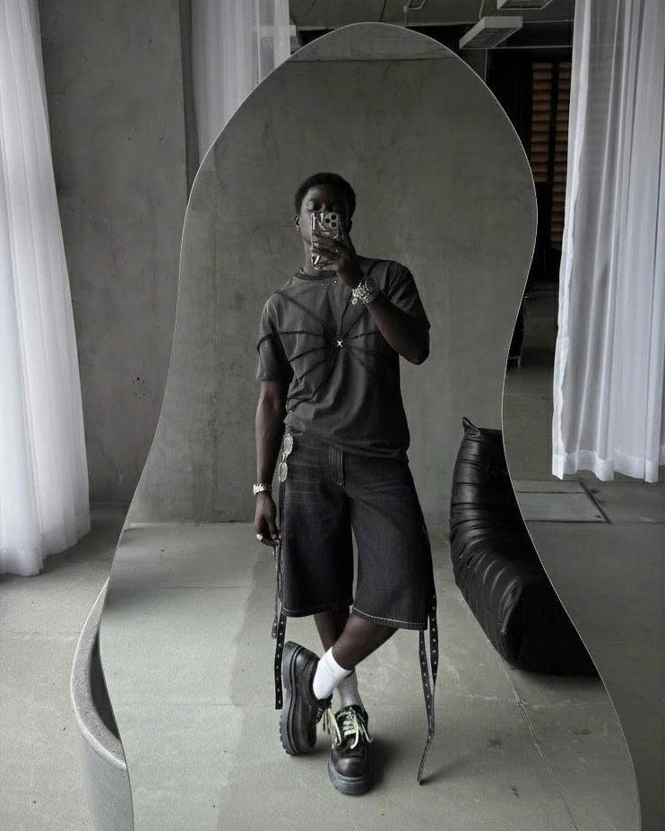 CARTWHEEL set featuring a black tie-dye top and cropped shorts with lace-up detail.